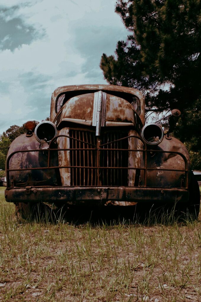 Old rusty car that could be sold for cash at a junkyard
