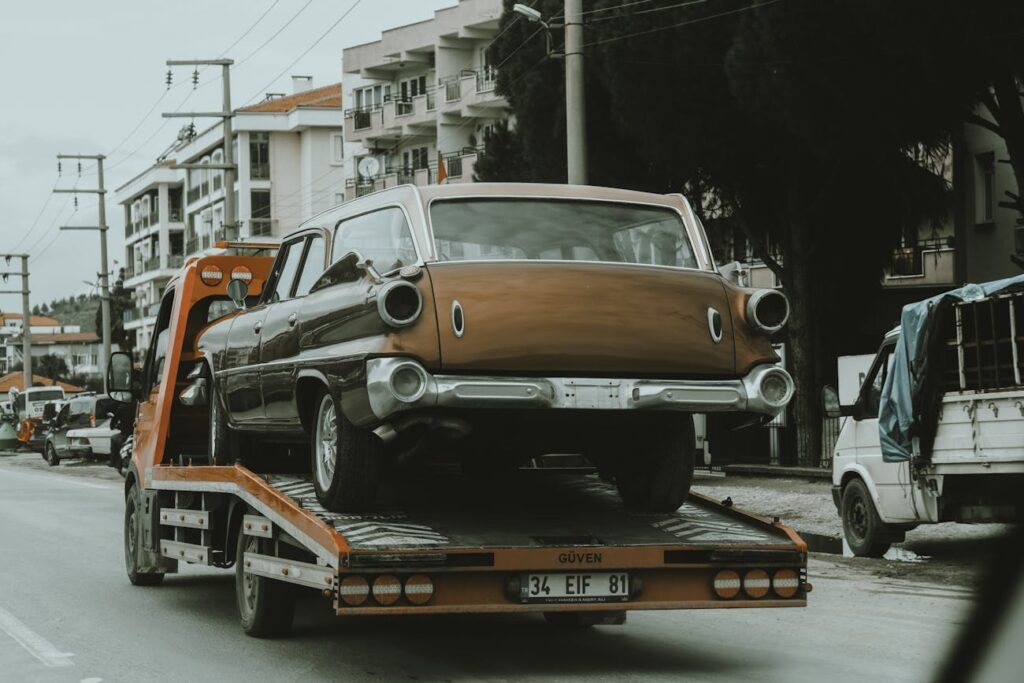 Tow truck carrying a car for junk car removal