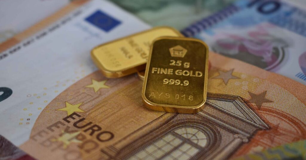 Gold bars and cash representing payment for dental gold crowns