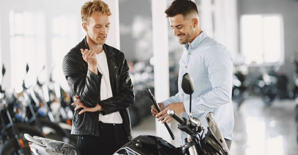 Motorcycle buyer reviewing a bike before a cash sale