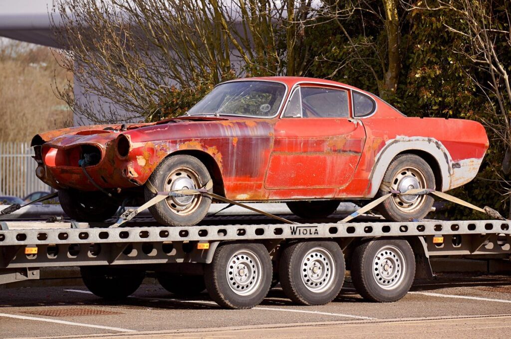 Older car loaded on a trailer before an unwanted car sale